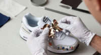 The Nike Air Max Muse "Floral Pack" Wraps Metallic Petal Hardware Around A White Leather Build